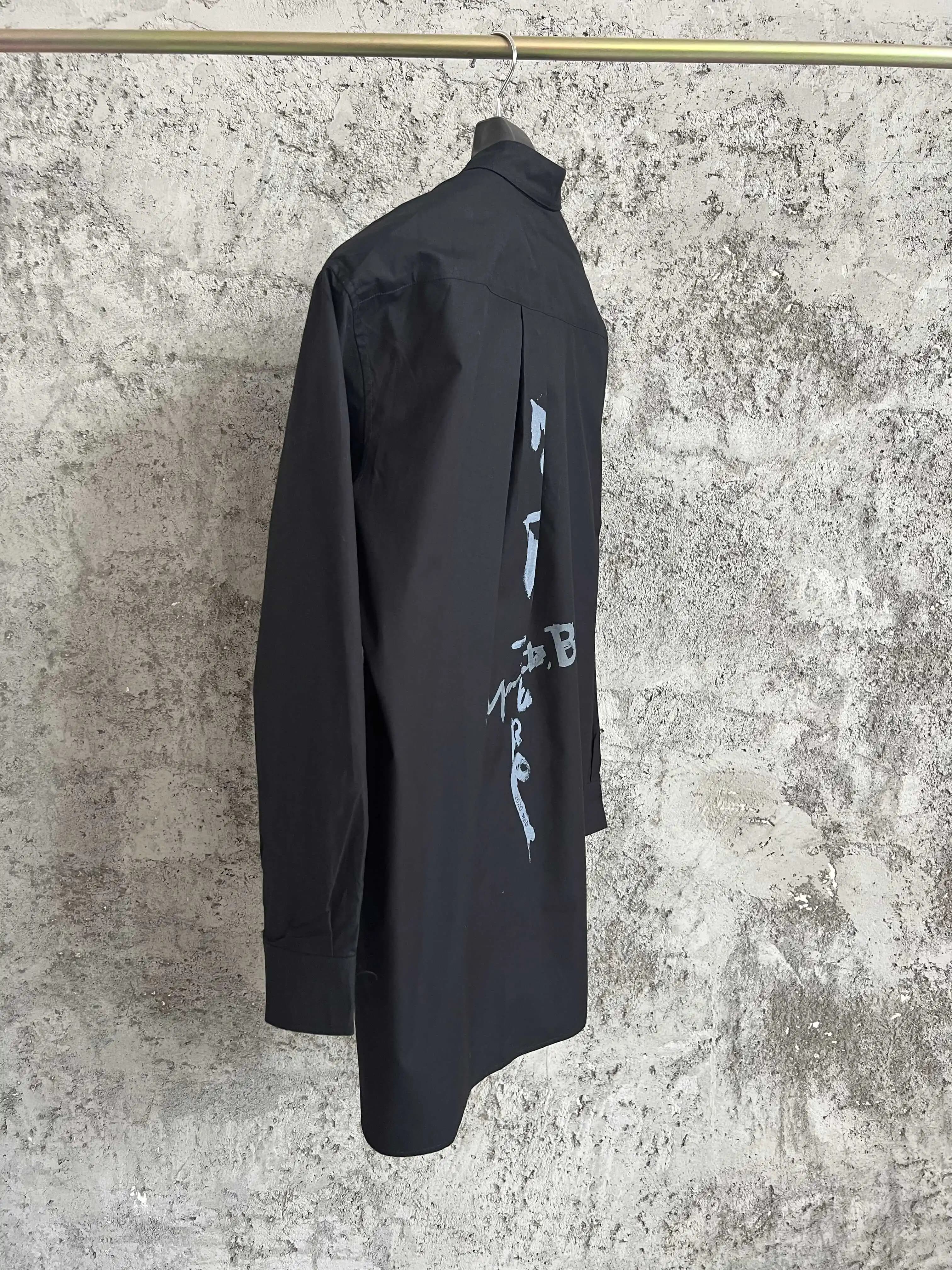 Une simple chemise simple boutonnage à manches longues avec un col double couche, couleur unie et de