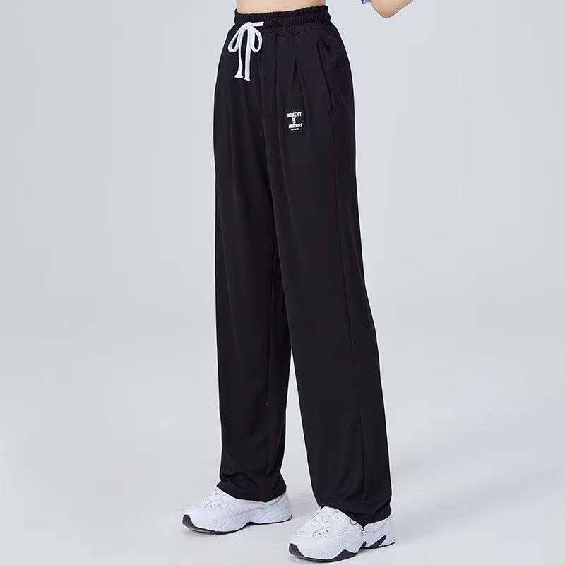 Mode poches élastiques couleur unie épissé pantalons décontractés vêtements pour femmes 2025 printem
