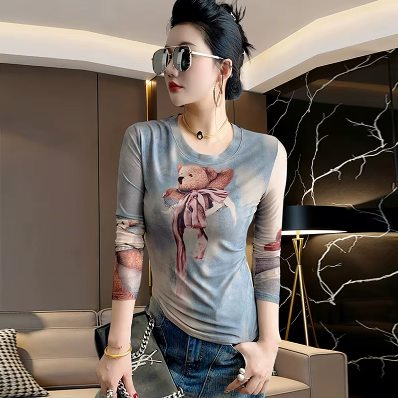 T-shirt européen pour femme MadBlack, col rond sexy imprimé dessin animé, haut moulant à manches lon